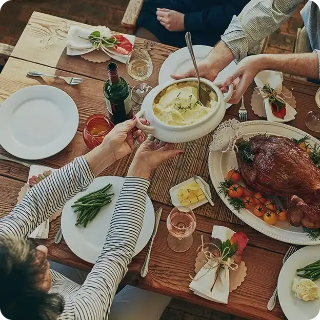 A group of people enjoying a big meal together.