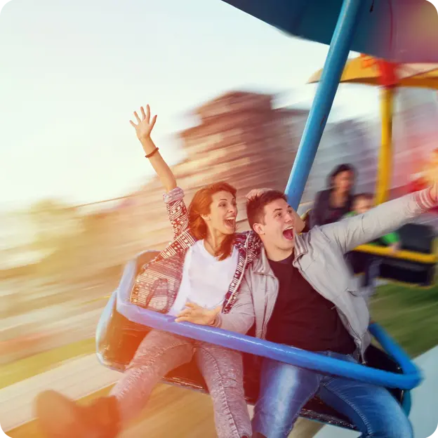 A couple enjoying an amusement park ride.
