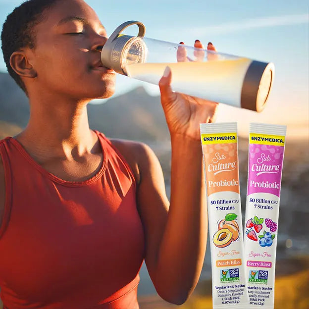 A woman drinking a water mixed with subculture stick packs.