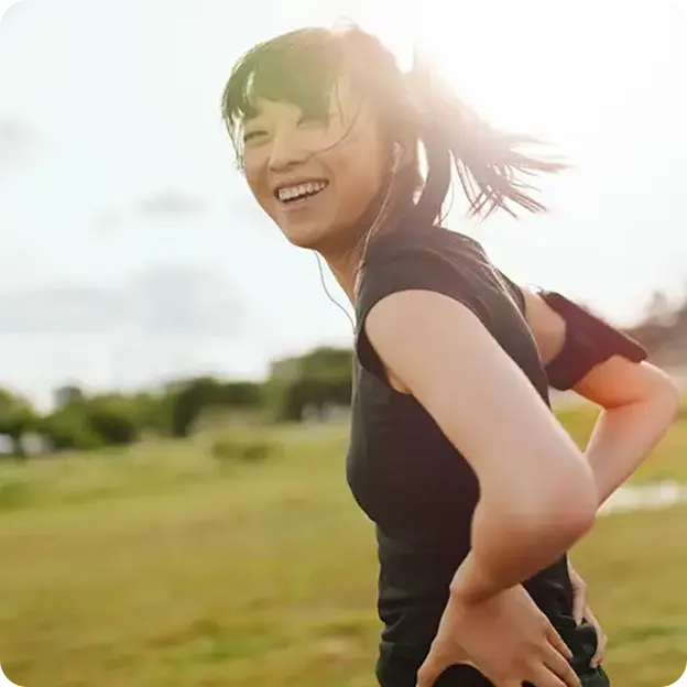 Woman smiling in a field.