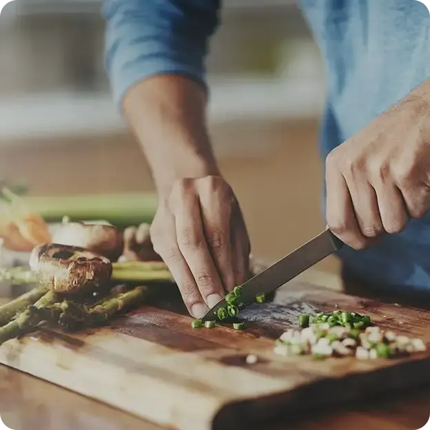 Person cutting up vegetables.