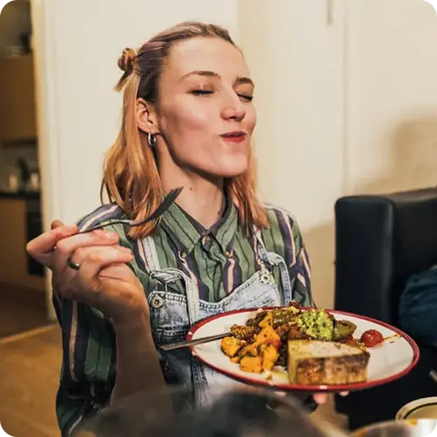 Woman enjoying her plate of food.
