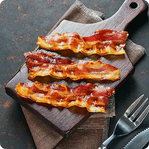 Bacon on a cutting board.