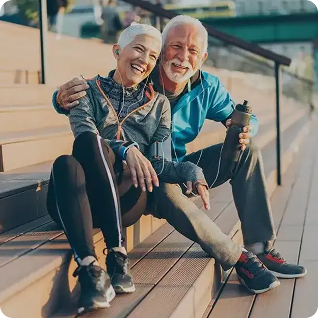An older couple sitting together after working out.